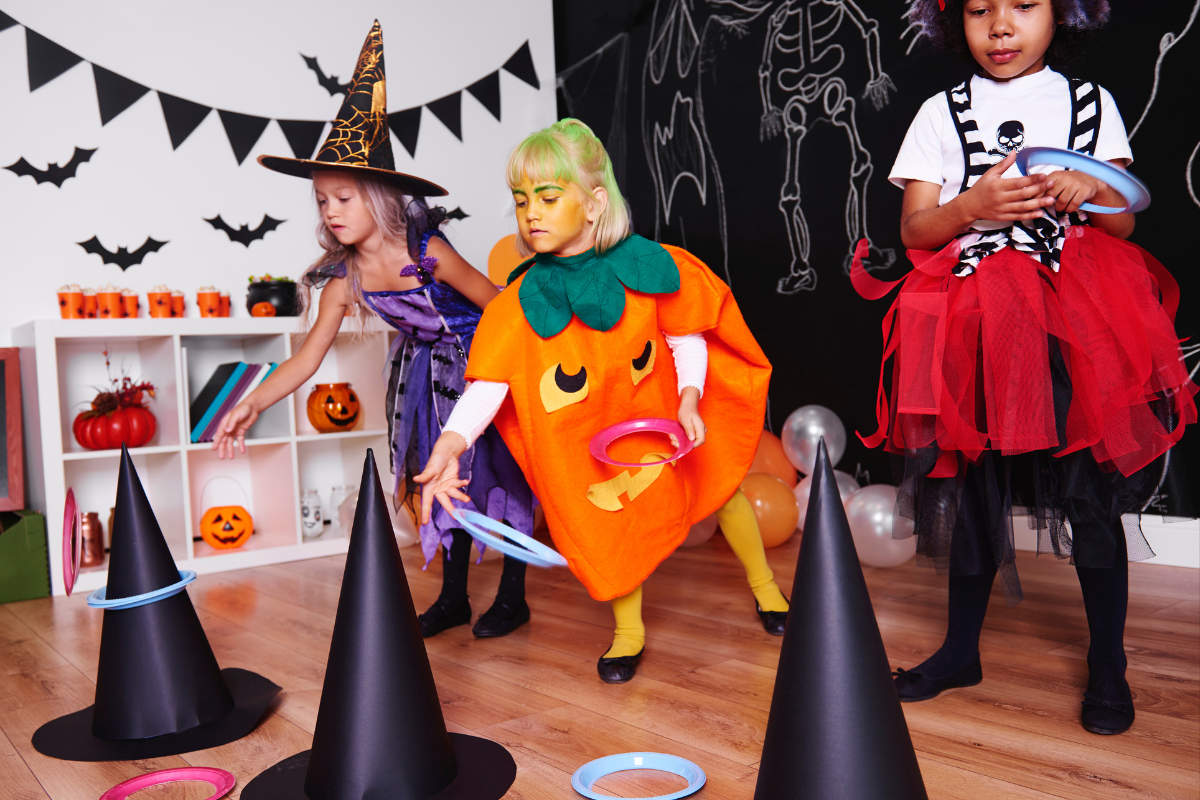 Three girls dressed up for halloween, playing a game