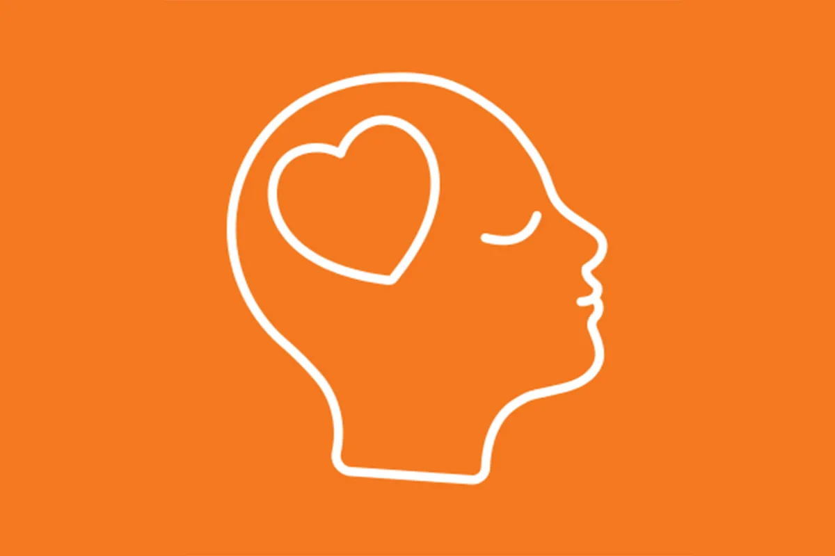 Outline of a human head in profile with a heart shape inside, symbolizing mental health or emotional well-being, set against an orange background.