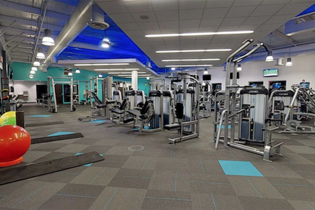 Modern fitness center with weight machines and exercise equipment.